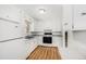Bright kitchen with modern white cabinets, appliances, and durable vinyl flooring at 387 Tucson St, Aurora, CO 80011