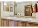 This bathroom features a double sink vanity with a large mirror and a vase of flowers on the counter at 4143 Eagle Ridge Way, Castle Rock, CO 80104