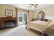 Spacious bedroom featuring a fireplace, French doors, and a beautiful four-poster bed with detailed wood work at 4143 Eagle Ridge Way, Castle Rock, CO 80104