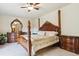 A bedroom featuring a beautiful four-poster bed and decorative wood furniture at 4143 Eagle Ridge Way, Castle Rock, CO 80104