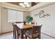 Bright dining room with tray ceiling, large windows, and stylish decor at 4143 Eagle Ridge Way, Castle Rock, CO 80104