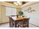 Bright dining room with a wooden table, stylish chairs, and decorative wall art at 4143 Eagle Ridge Way, Castle Rock, CO 80104