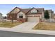 Charming single-Gathering home with a two-car garage, brick accents, and a well-manicured lawn and driveway at 4143 Eagle Ridge Way, Castle Rock, CO 80104