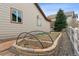 Side view of a raised garden bed featuring stone bricks, black irrigation lines, and a growing evergreen tree at 4143 Eagle Ridge Way, Castle Rock, CO 80104