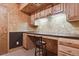 Cozy home office space featuring wood cabinetry, textured walls, and a built in desk with a sleek black countertop at 4143 Eagle Ridge Way, Castle Rock, CO 80104