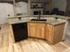 Modern kitchen island with granite countertops, sink, and black dishwasher at 4143 Eagle Ridge Way, Castle Rock, CO 80104