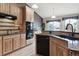 Bright kitchen featuring granite countertops, modern appliances, and light wood cabinets at 4143 Eagle Ridge Way, Castle Rock, CO 80104