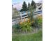 Eye-catching landscaping featuring vivid orange daylilies along a pristine white fence at 4143 Eagle Ridge Way, Castle Rock, CO 80104