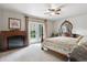 The main bedroom boasts carpet, a fireplace, french doors and beautiful furniture at 4143 Eagle Ridge Way, Castle Rock, CO 80104