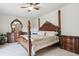 Elegant main bedroom with a large bed, wooden furniture, carpet and neutral walls at 4143 Eagle Ridge Way, Castle Rock, CO 80104