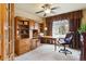 This is a home office that features wood built ins, a ceiling fan, and a large window for natural light at 4143 Eagle Ridge Way, Castle Rock, CO 80104