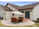 Outdoor patio with dining furniture covered by a large umbrella, situated next to the house with beige siding at 4143 Eagle Ridge Way, Castle Rock, CO 80104