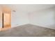 Carpeted bedroom featuring neutral walls and access to hallway at 20351 E Lasalle Pl, Aurora, CO 80013