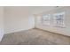 Spacious carpeted bedroom with neutral walls and three windows at 20351 E Lasalle Pl, Aurora, CO 80013