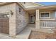 Front entrance of a brick house with a brown door and white railing at 20351 E Lasalle Pl, Aurora, CO 80013