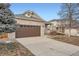 Brick house with a brown garage door and a partially visible neighboring house at 20351 E Lasalle Pl, Aurora, CO 80013