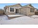 Brick house exterior with sliding glass door and snow at 20351 E Lasalle Pl, Aurora, CO 80013