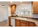 Kitchen with oak cabinets, a double sink, and a view into the living room at 20351 E Lasalle Pl, Aurora, CO 80013