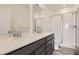 Bathroom featuring double sinks, a shower, and stylish tile flooring at 6562 Arbor Blvd # 3, Thornton, CO 80602