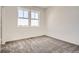 Bedroom with large windows and plush carpet at 6562 Arbor Blvd # 3, Thornton, CO 80602