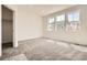 Spacious bedroom with plush carpeting and natural light from three windows at 6562 Arbor Blvd # 3, Thornton, CO 80602