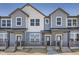 Charming townhome with light blue siding and a covered front porch at 6562 Arbor Blvd # 3, Thornton, CO 80602