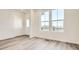 Open-concept living room with large windows and hardwood flooring at 6562 Arbor Blvd # 3, Thornton, CO 80602