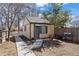 A backyard shed with matching trim, a barbecue grill, and a walkway enhance this home's functional outdoor space at 1343 Valentia St, Denver, CO 80220