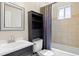 Well-lit bathroom with a modern vanity, cabinet, and a shower-tub combo, offering a comfortable and functional space at 1343 Valentia St, Denver, CO 80220