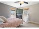 Comfortable bedroom with natural light, a dresser, and windows, creating a relaxing retreat at 1343 Valentia St, Denver, CO 80220