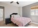 Cozy bedroom with plush pink bedding, black nightstand, and soft lighting creates a peaceful and inviting retreat at 1343 Valentia St, Denver, CO 80220