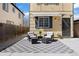Charming home exterior featuring a covered patio with stylish seating and well-maintained landscaping at 1343 Valentia St, Denver, CO 80220