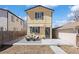 Charming home exterior with a cozy front patio, awning, and beautifully landscaped front yard at 1343 Valentia St, Denver, CO 80220
