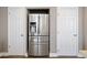 A stainless steel refrigerator with water and ice dispenser is nestled between two doors, maximizing space at 1343 Valentia St, Denver, CO 80220