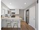 Bright kitchen with stainless steel appliances, white cabinets, breakfast bar, and wood floors offers a modern, functional design at 1343 Valentia St, Denver, CO 80220