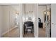 Vanity area is illuminated by ring lights in a walk-in closet between mirrored sliding doors at 1343 Valentia St, Denver, CO 80220