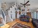 Open-concept living room with high ceilings, a staircase, hardwood floors, and a view into the dining area at 6348 Deframe Way, Arvada, CO 80004