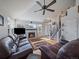 Bright and airy living room with a fireplace, hardwood floors, and staircase leading to the upper level at 6348 Deframe Way, Arvada, CO 80004