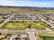 Expansive view of the neighborhood showcasing open green spaces, winding walking trails and mountain views at 14102 Night Owl Ln, Parker, CO 80134