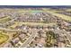Sprawling residential area featuring a mix of single-Gathering homes and green spaces with a lake in the distance at 14102 Night Owl Ln, Parker, CO 80134