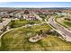 Aerial view of a green neighborhood park with walking paths, gazebo, and manicured landscaping at 14102 Night Owl Ln, Parker, CO 80134