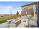 Outdoor kitchen and lounge featuring a built-in grill, a fire pit, and comfortable seating at 14102 Night Owl Ln, Parker, CO 80134