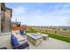 Spacious backyard with a patio, fire pit, seating, and a well-maintained lawn at 14102 Night Owl Ln, Parker, CO 80134