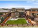 Aerial view of a fenced backyard with a lush lawn, patio with seating, and well-maintained landscaping at 14102 Night Owl Ln, Parker, CO 80134