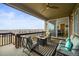 Inviting covered deck with comfortable seating, a fire pit, and scenic views at 14102 Night Owl Ln, Parker, CO 80134