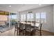 Bright dining room with large table and view to the outside deck and neighborhood at 14102 Night Owl Ln, Parker, CO 80134