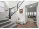 Light-filled entryway featuring a staircase, hardwood floors, and view into living room at 14102 Night Owl Ln, Parker, CO 80134