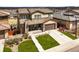 Aerial view of a suburban home with a tile roof, manicured lawn, and neighborhood in the background at 14102 Night Owl Ln, Parker, CO 80134