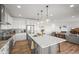 Open concept kitchen featuring a center island, pendant lights, and views of the living area at 14102 Night Owl Ln, Parker, CO 80134