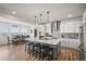 Open concept kitchen featuring a center island, pendant lights, and views of the dining area at 14102 Night Owl Ln, Parker, CO 80134